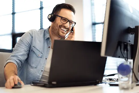 smiling-man-on-headset-working-to-increase-call-center-productivity.webp