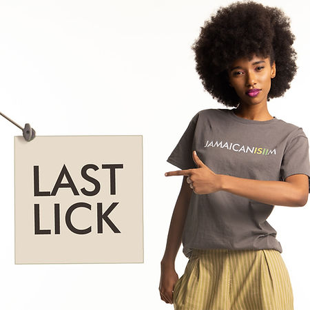 a model wearing a Jamaicanisiim tshirt pointing at a sign with the words last lick
