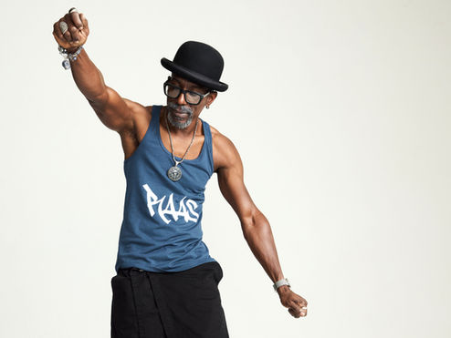 A man dancing wearing a blue graphic tank style t-shirt with the word Raas