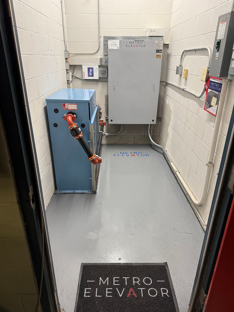 Hydraulic elevator machine room with hydraulic tank and control equipment used during pressure testing