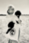 girl carrying a choice bernedoodle bag with 2 mini bernedoodle puppies