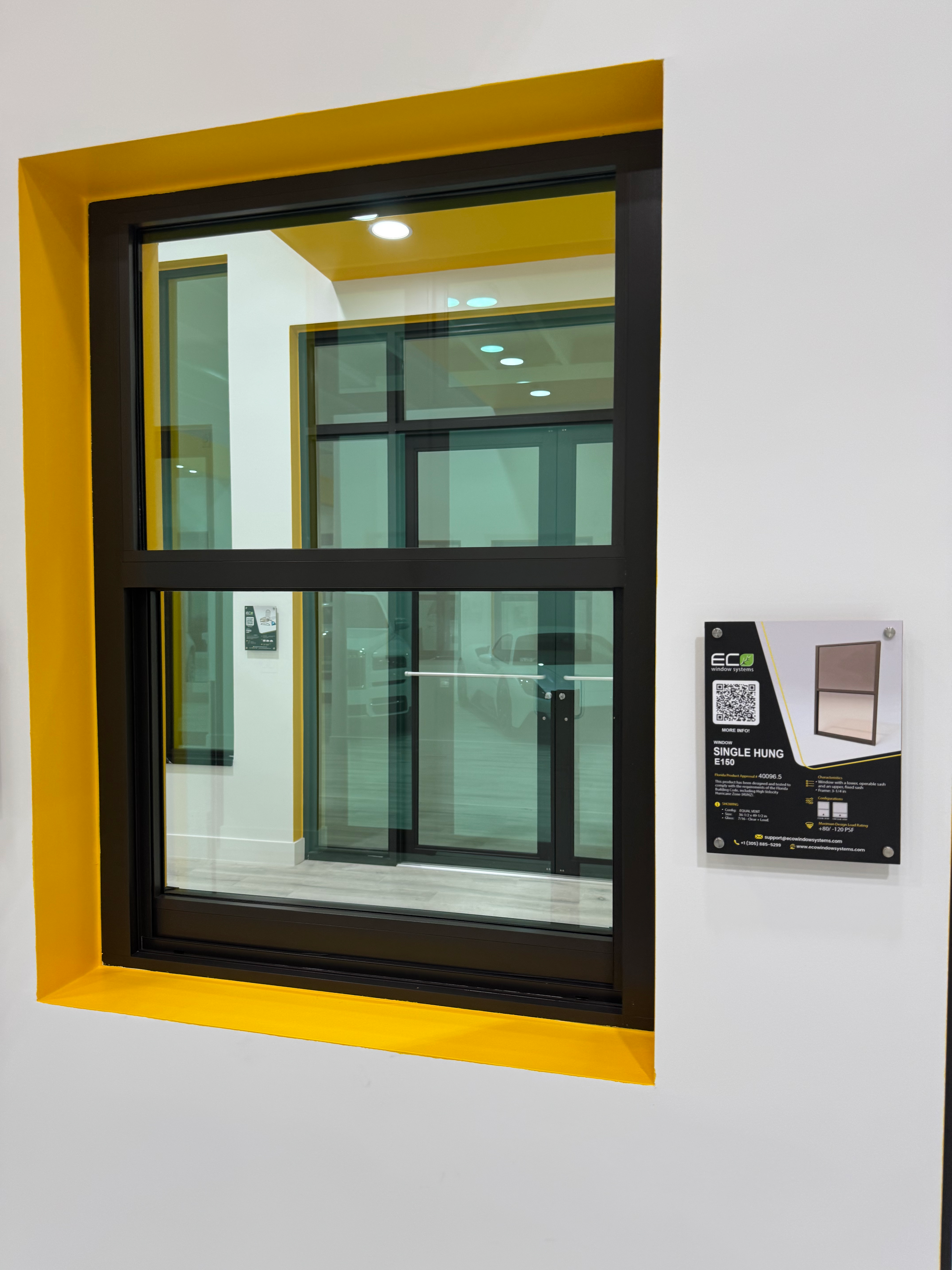 Black framed window sample at the IMPACT WINDOWS WIN showroom. ECO NOVO-775 Sliding glass door.