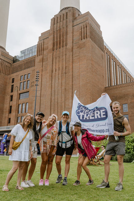 Group of charity walkers posing together outside Battersea Power Station photographed by activist photographer Luana Martignon