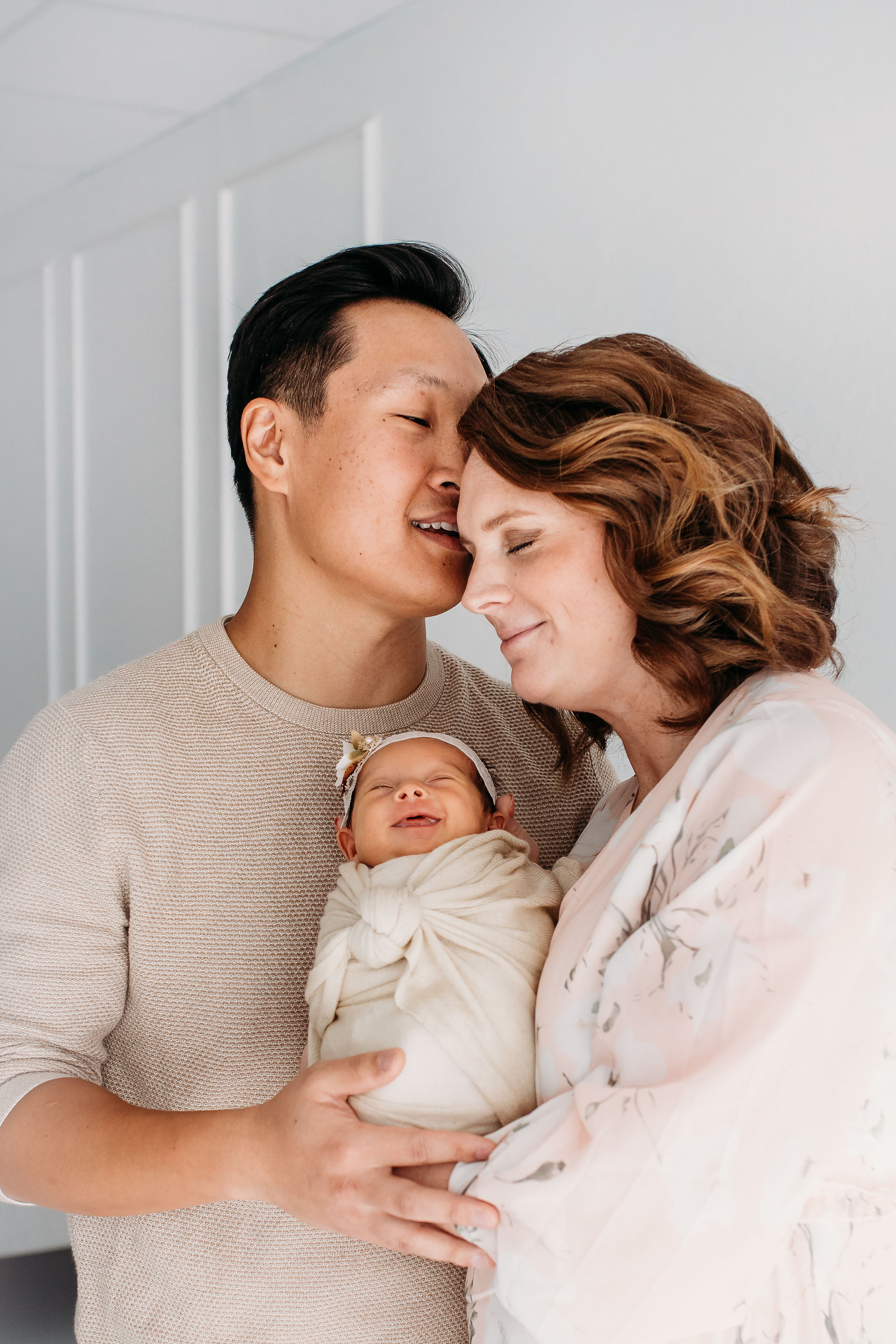 Couple intimate moment holding newborn baby