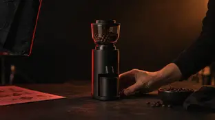 Positioning a coffee grinder on a dark product filming set