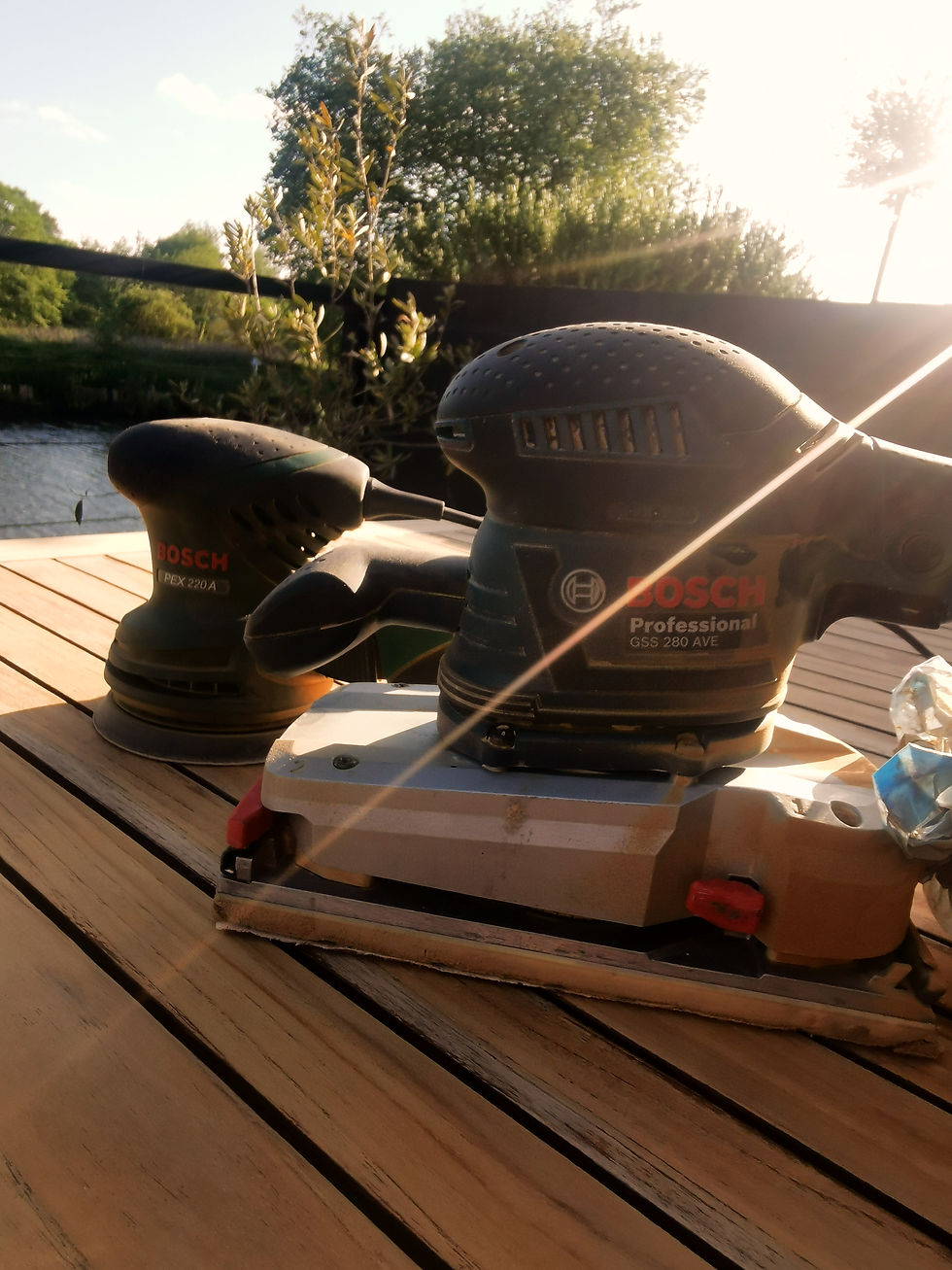bosch belt sander and orbital sander on garden table in sunlight