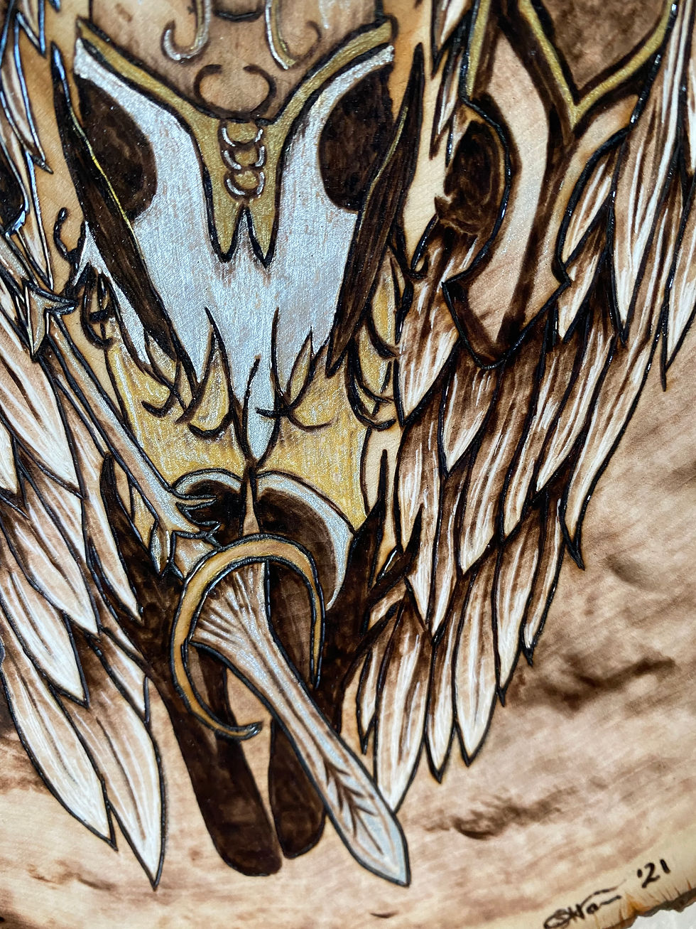Thumbnail: Intricate woodburning artwork: winged skull, sword, 21