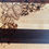 Thumbnail: Wooden cutting board with woodburned grapes and leaves