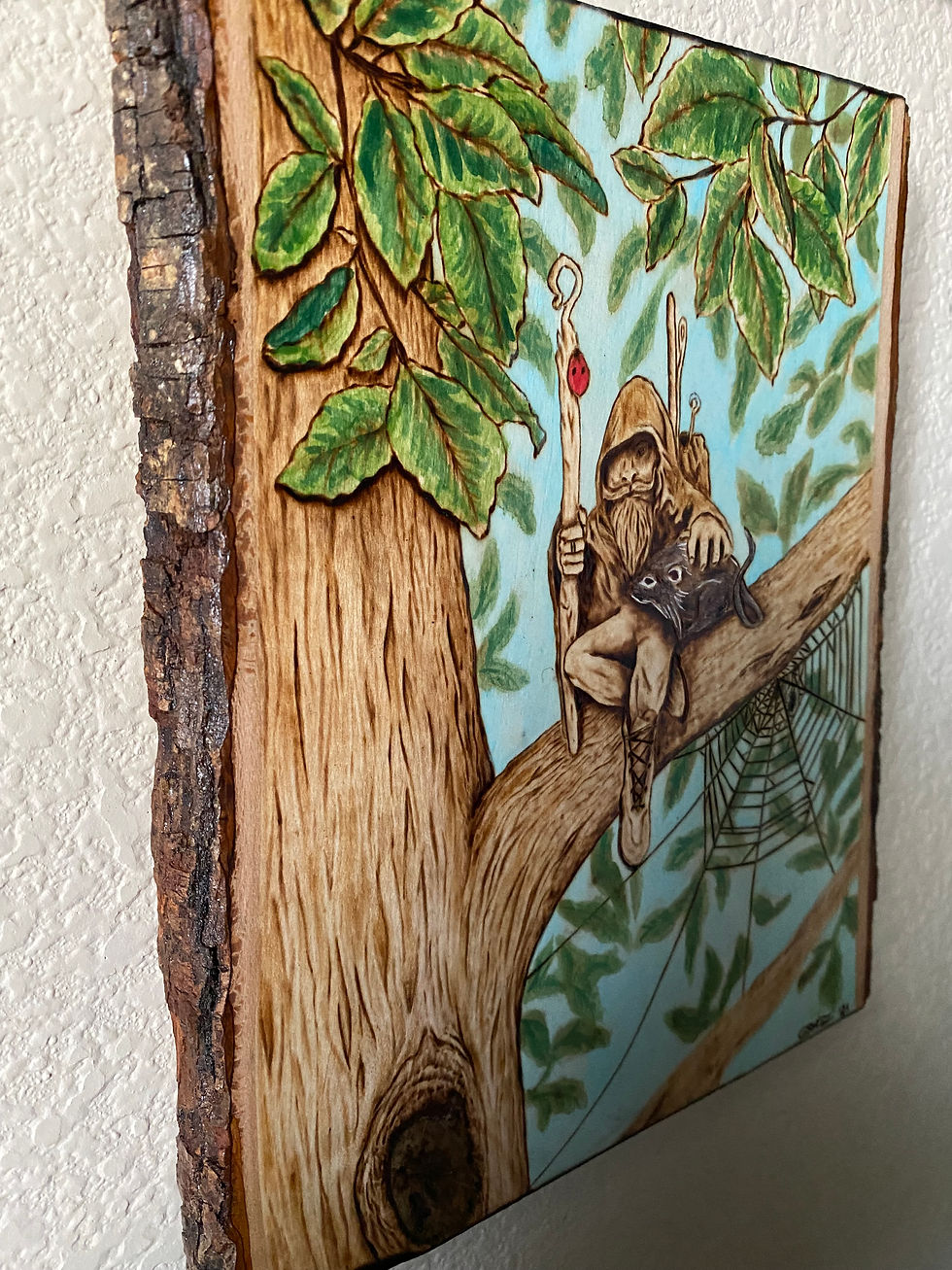 Thumbnail: Woodburned gnome with cat sits on tree branch
