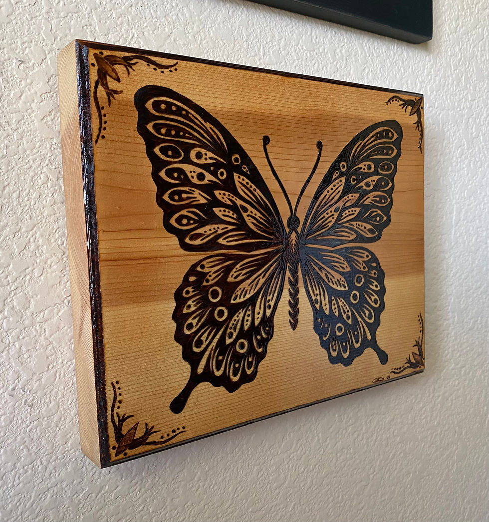 Thumbnail: Intricate wood-burned butterfly art