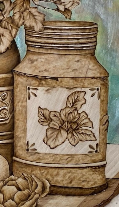 Thumbnail: Intricate woodburned jar, floral design, rustic still life
