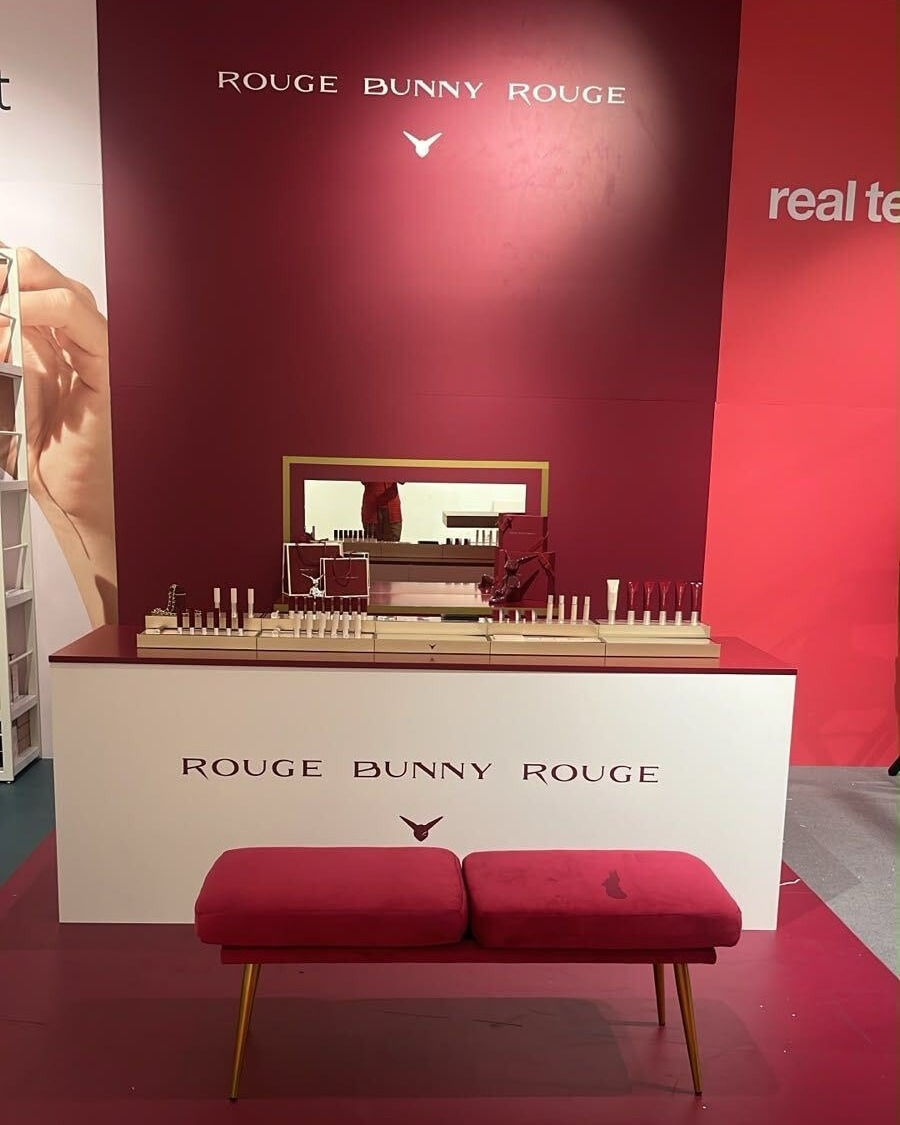 Rouge Bunny Rouge podium with lipsticks, complexion products and rabbit sculptures at Rinascente