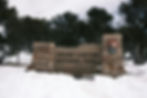 The entrance sign to Grand Canyon National Park covered in snow.