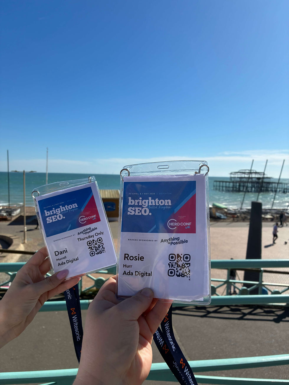 Dani and Rosie's brightonSEO passes held next to Brighton's old pier