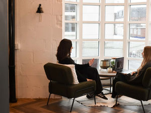 Carrie and Scarlett at ADA Digital sat on green chairs talking about SEO