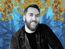 A BLACK AND WHITE IMAGE OF ARTIST LUKE ADAM HAKWER. THE BACKGROUND IS BLUE AND YELLO