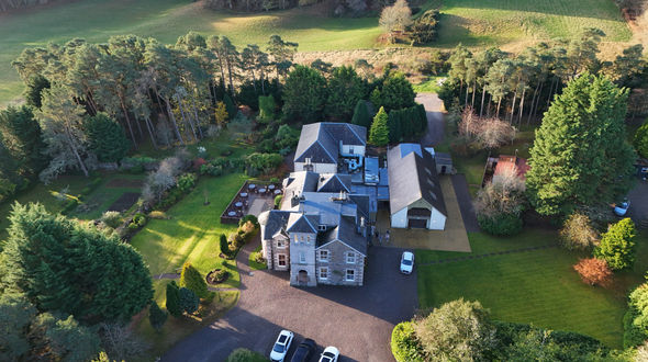 Drone photo of Loch Ness Country House Hotel looking down to the main entrance