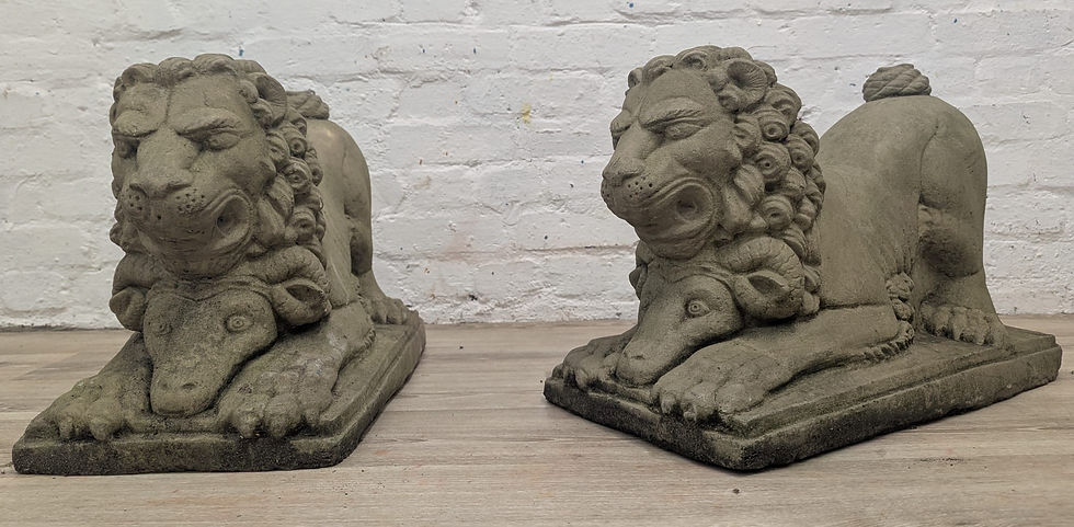 Pair of weathered cast stone pouncing lion on ram statues