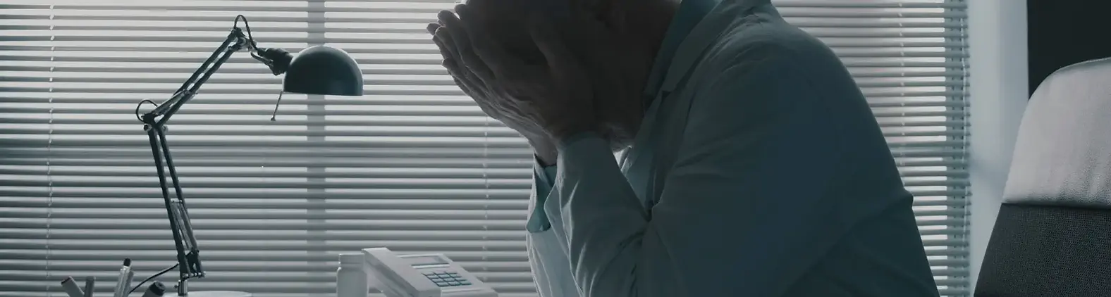 Professional in an office setting reflecting on the high risk of relapse for employees returning from burnout without structured support.