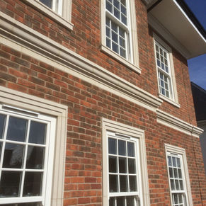Upvc sliding sash windows from Rehau heritage with full georgian bars supplied and fitted on a new build property in Enfield hertfordshire