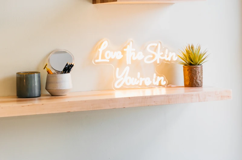picture of a light that says love the skin you're in