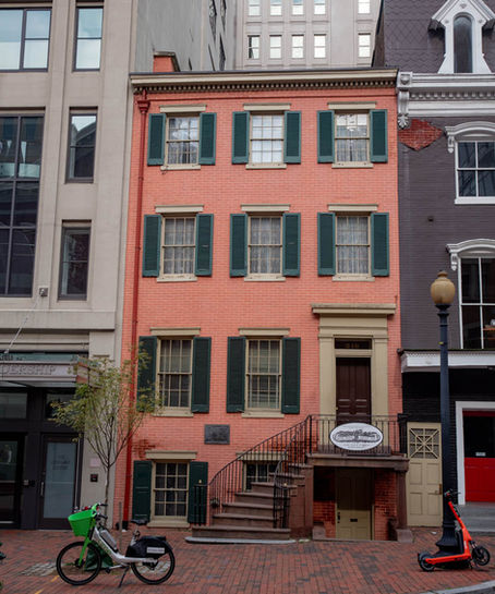 Petersen House sits between two modern buildings on either side.