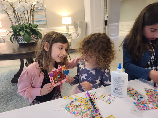 Happy guests holding completed craft projects