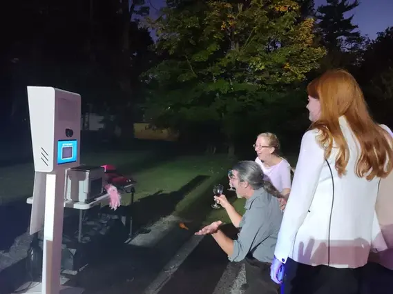 Capturing cherished memories: A lively photo booth experience at a graduation party, where graduates and guests strike poses and create lasting mementos.