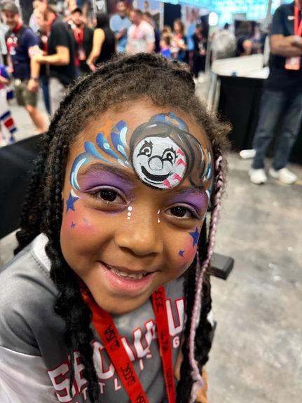 Child smiling with custom face paint
