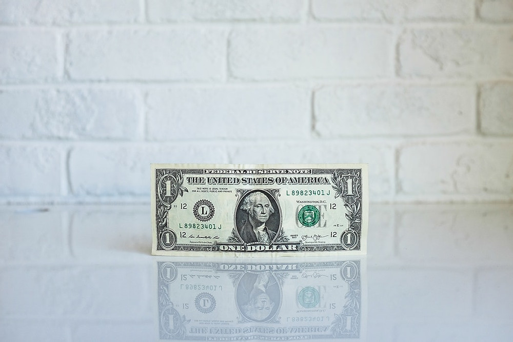 dollar bill against white wall where to spend lead generation budget