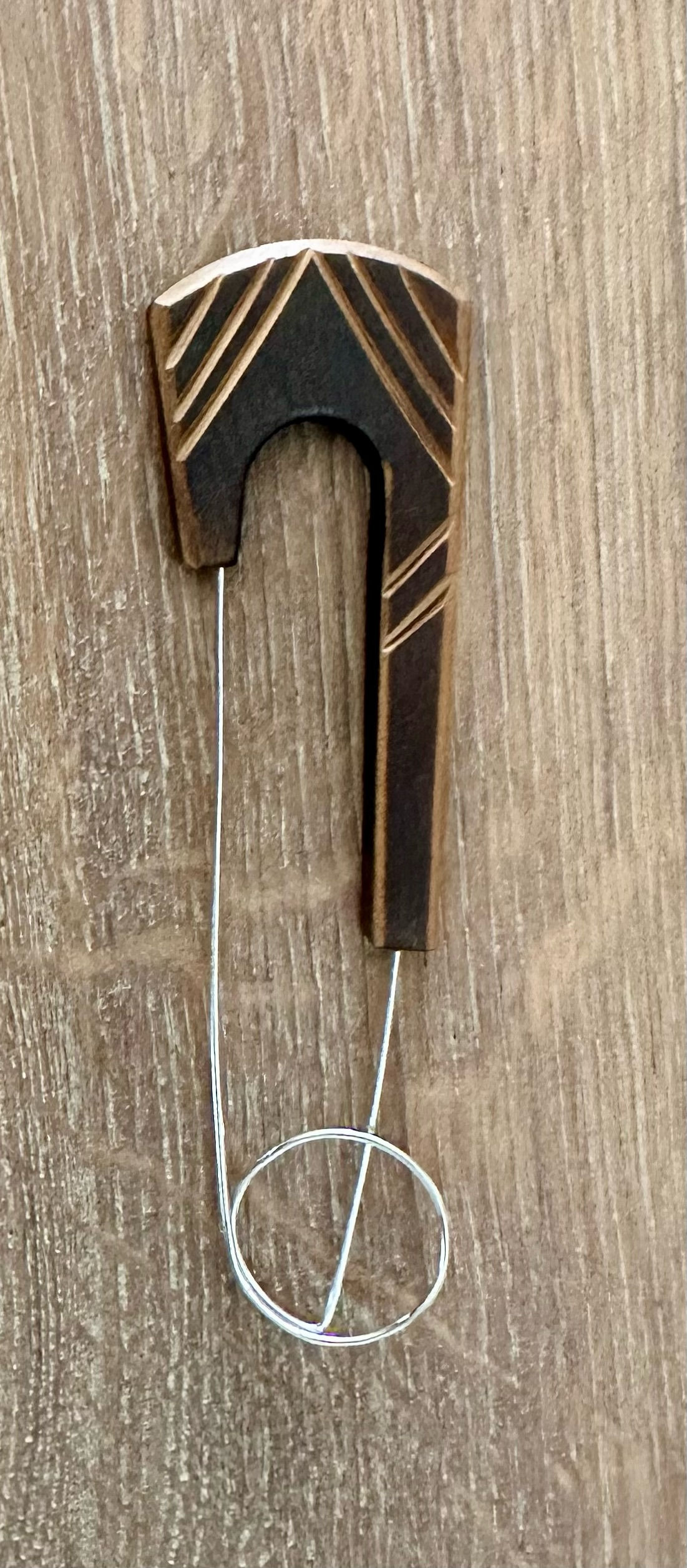 Dark coloured coconut shawl pin with lighter stripes