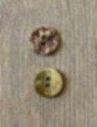 Metal buttons with bordeaux print, one from the front and one from the back