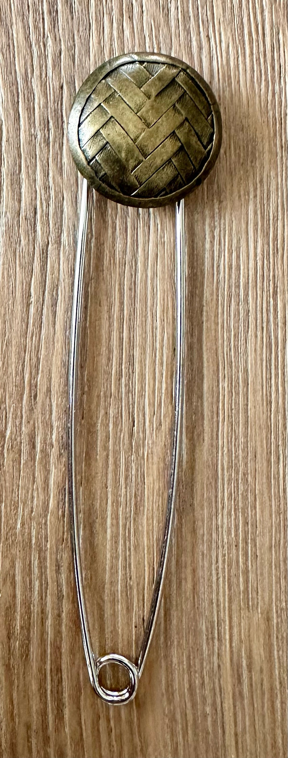 Copper shawl pin with a woven detail