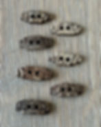 7 small rectangular coconut buttons in varying shades
