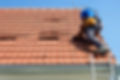 Loose tiles on a roof being repaired
