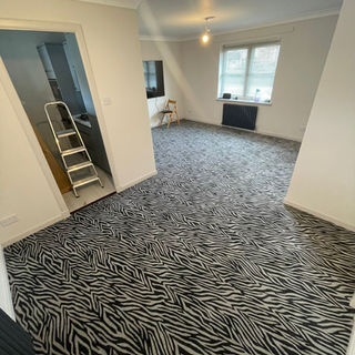 A large room with an animal print carpet