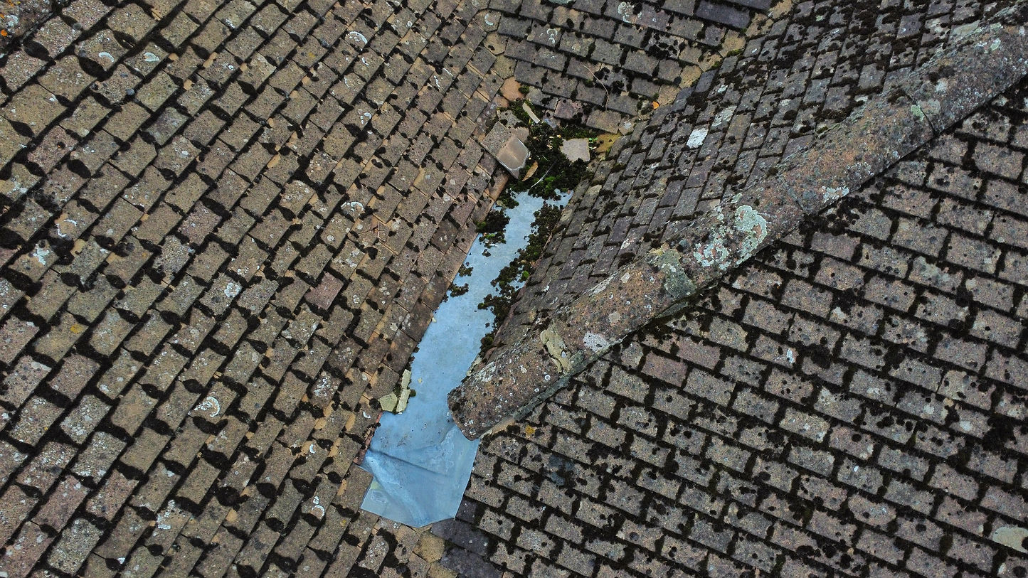 A drone survey showing a roof's damage and dirt