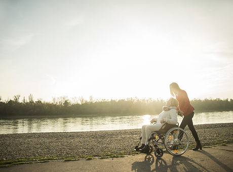 Carer assisting patient sitting in wheelchair.jpg