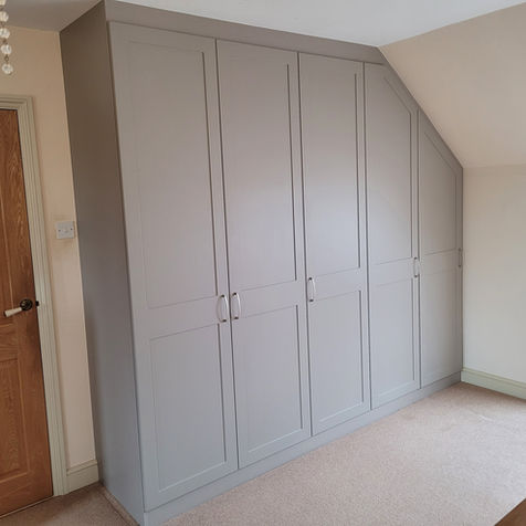 A bespoke fitted angled wardrobe