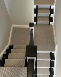 Neutral beige stair runner carpet with distinct black borders