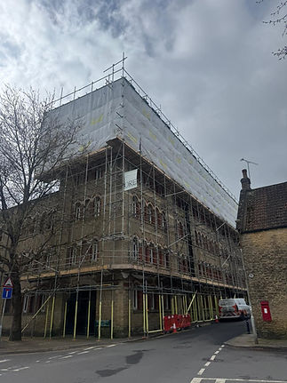 Victorian stone building covered in scaffolding and sheeting during renovation works