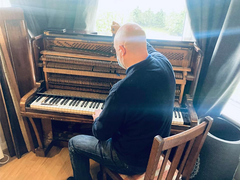 Bringing a piano back to life with piano repairing services.PNG