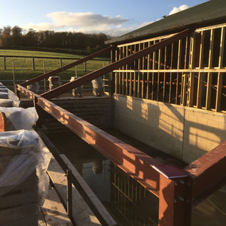 An outbuilding's roof being repaired
