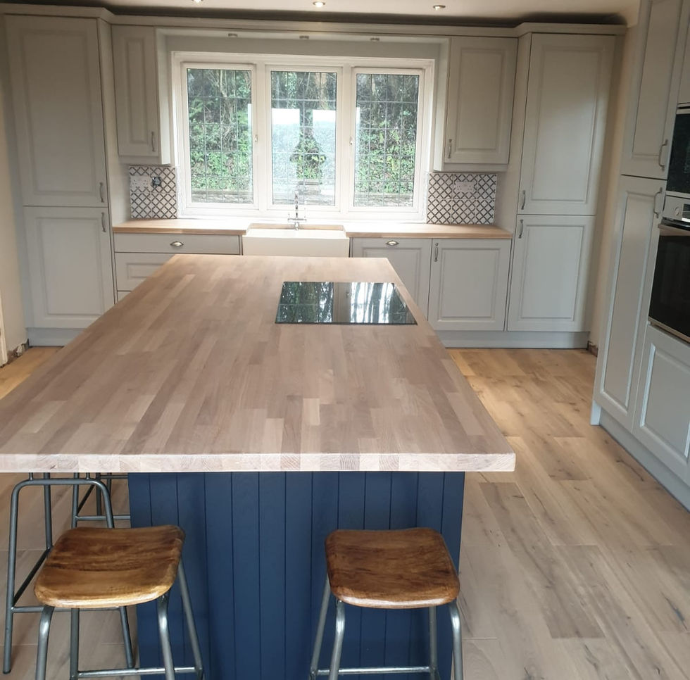 A newly installed bespoke kitchen featuring a large central island and perimeter cabinetry