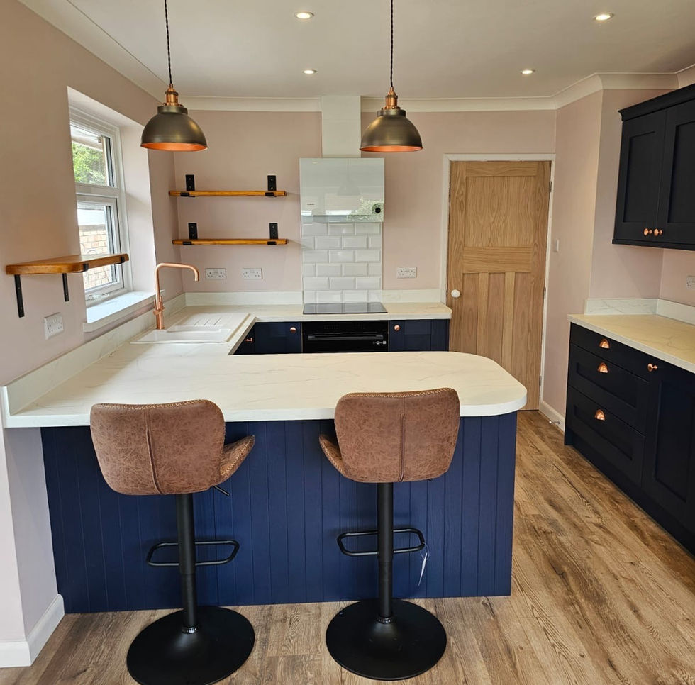 A modern kitchen featuring a navy blue island and cabinets contrasted with light worktops