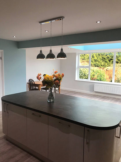 A modern open-plan kitchen and dining area with a large central kitchen island