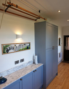 A kitchen and utility area featuring bespoke cabinetry