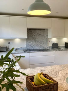 A modern kitchen with several key features. The countertops and backsplash