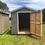 Thumbnail: 8x12 Standard gray color, Gable roof w/ end door & vented overhang 