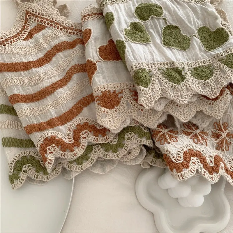 embroidered summer tank tops, zoomed in at bottom